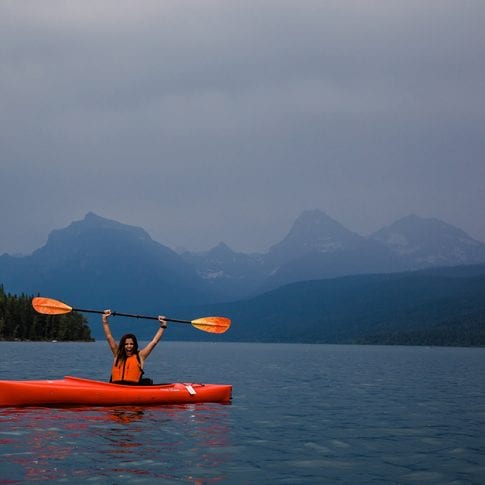 woman kayaking in glacier national park
