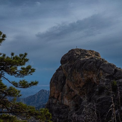 person standing far out on mountain at mount lemmon